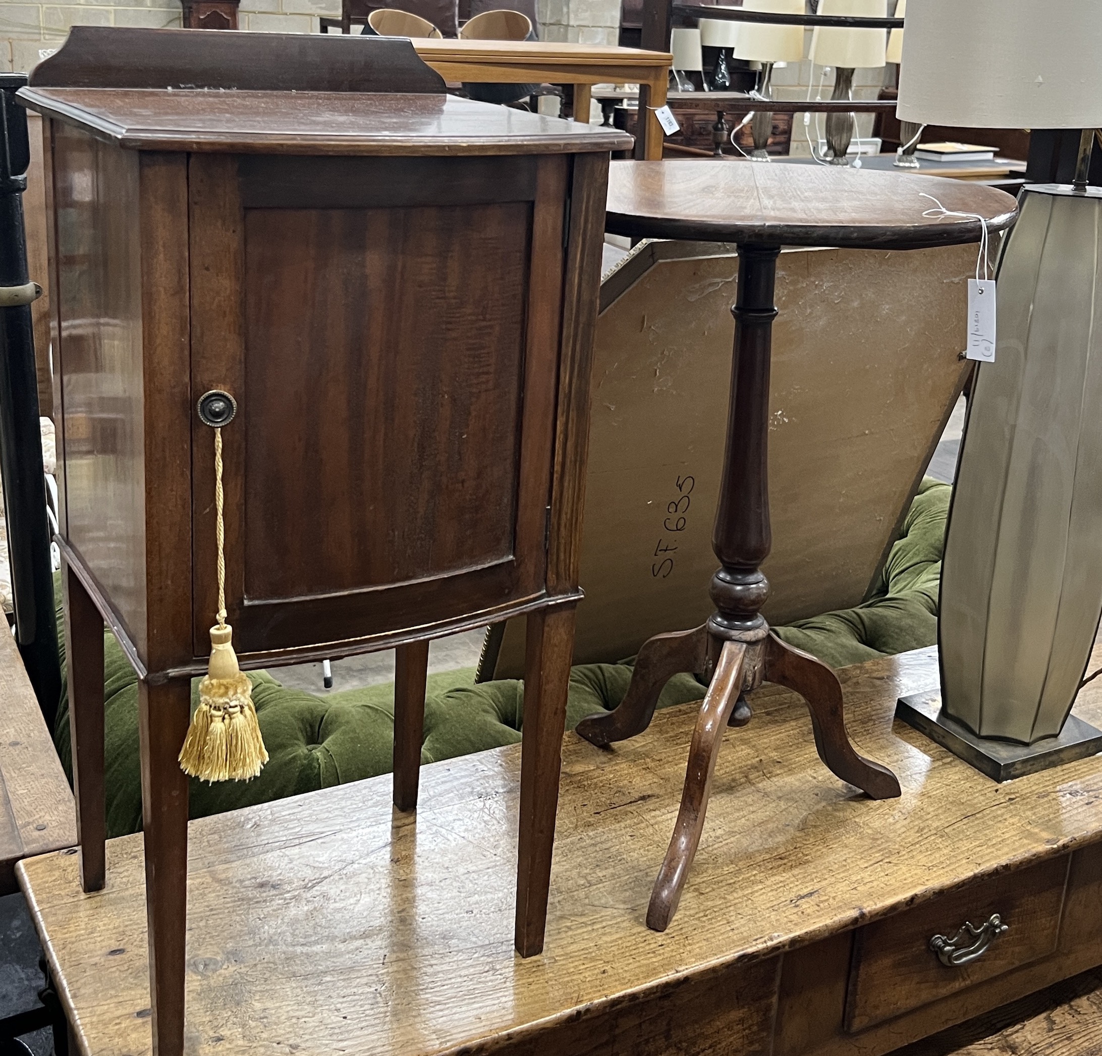 An Edwardian mahogany bow front bedside cabinet, width 40cm, height 82cm together with a Victorian circular wine table